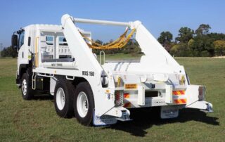 White skip loader truck